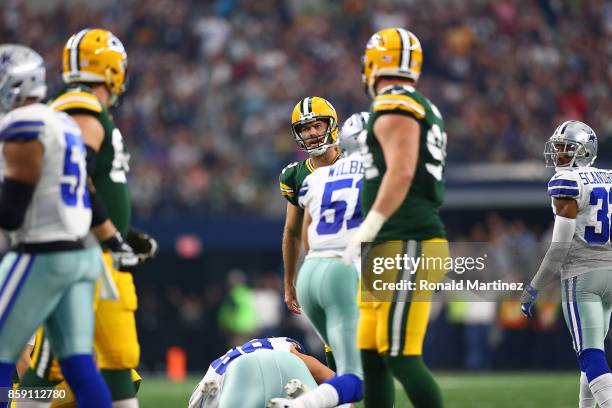 Mason Crosby of the Green Bay Packers reacts after missing his second extra point attempt in the second quarter against the Dallas Cowboys at AT&T...