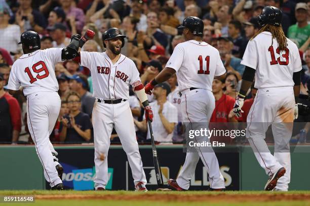 Dustin Pedroia of the Boston Red Sox celebrates after Jackie Bradley Jr. #19 hit a three-run home run in the seventh inning against the Houston...