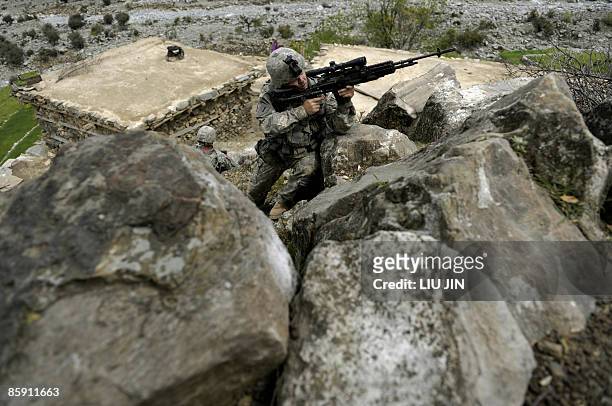Soldier from 1st Infantry Division stands alert with a rifle during a mission to search for a weapon cache at Alaugal valley in Nishagam, in...