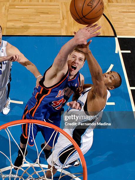 David Lee of the New York Knicks battles for a rebound with Rashard Lewis of the Orlando Magic during the game on April 10, 2009 at Amway Arena in...