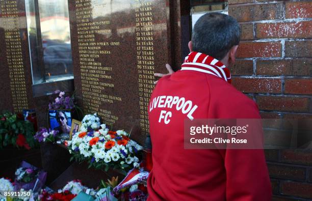 Liverpool fan pays his respects to those who died in the Hillsborough disaster prior to the Barclays Premier League match obetween Liverpool and...