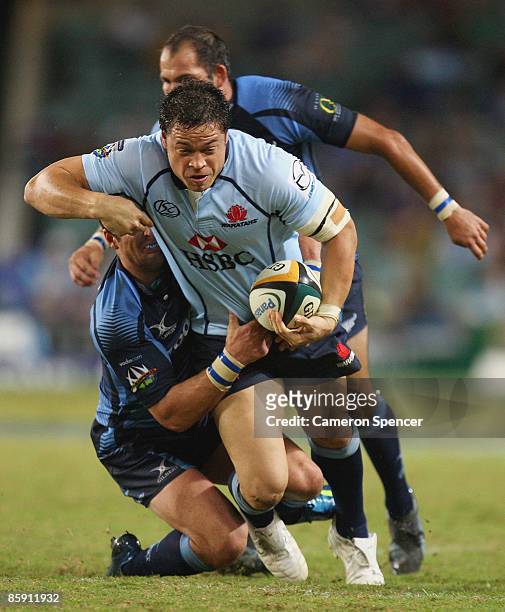 Timana Tahu of the Waratahs is tackled during the round nine Super 14 match between the Waratahs and the Bulls at the Sydney Football Stadium on...
