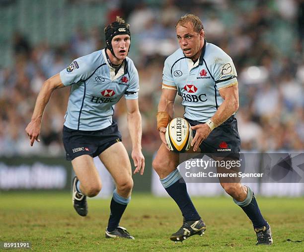 Waratahs captain Phil Waugh runs the ball with team mate Sam Norton-Knight in support during the round nine Super 14 match between the Waratahs and...