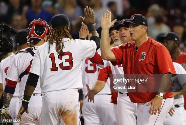 Manager John Farrell of the Boston Red Sox high fives Hanley Ramirez after defeating the Houston Astros 10-3 in game three of the American League...