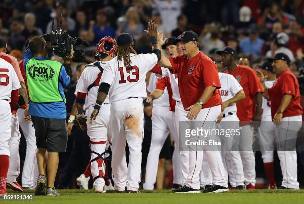 Manager John Farrell of the Boston Red Sox high fives Hanley Ramirez after defeating the Houston Astros 10-3 in game three of the American League...