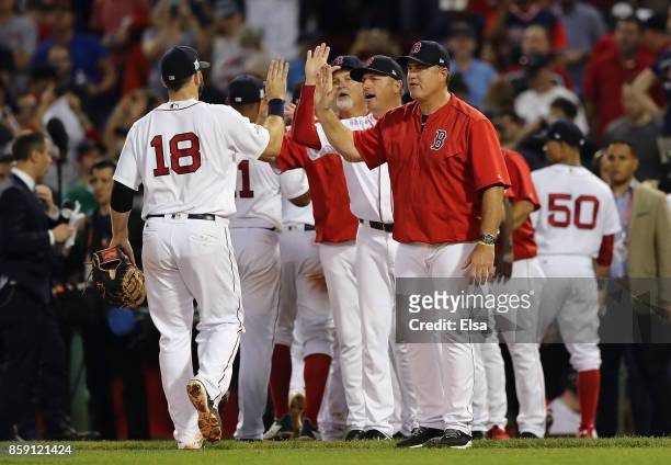 Manager John Farrell of the Boston Red Sox high fives Mitch Moreland after defeating the Houston Astros 10-3 in game three of the American League...