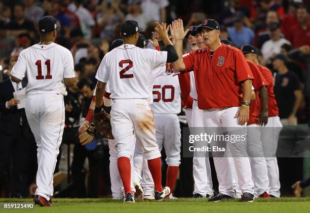 Manager John Farrell of the Boston Red Sox high fives Xander Bogaerts after defeating the Houston Astros 10-3 in game three of the American League...