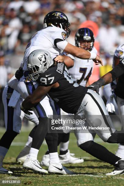 Mario Edwards of the Oakland Raiders hits Joe Flacco of the Baltimore Ravens during their NFL game at Oakland-Alameda County Coliseum on October 8,...