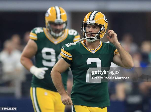 Mason Crosby of the Green Ba Packers walks off after missing a point after attempt in the first half of a football game against the Dallas Cowboys at...