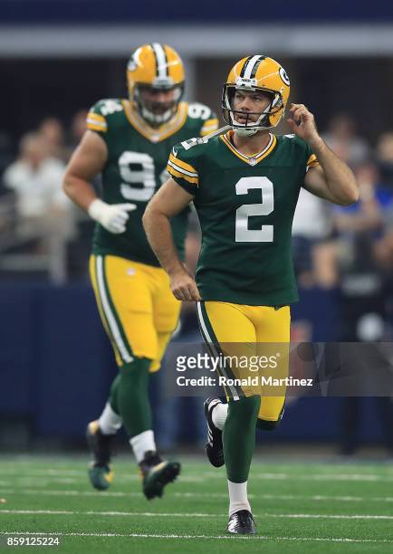 Mason Crosby of the Green Ba Packers walks off after missing a point after attempt in the first half of a football game against the Dallas Cowboys at...