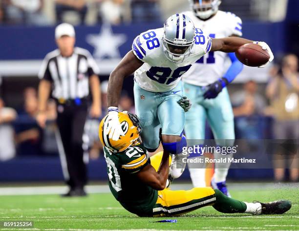 Kevin King of the Green Ba Packers pulls down Dez Br ant of the Dallas Cowboys in the first half of a football game at AT&T Stadium on October 8,...