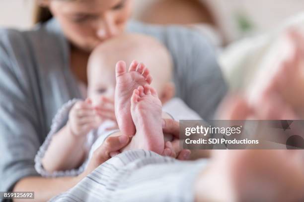 tiny baby feet - foot kiss stock pictures, royalty-free photos & images