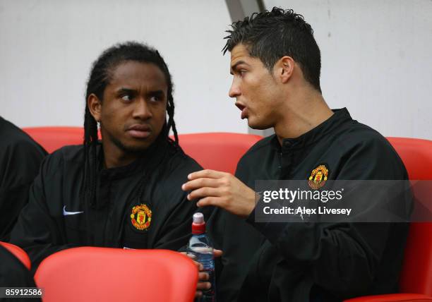 Cristiano Ronaldo of Manchester United chats with team mate Anderson as they sit on the bench prior to the Barclays Premier League match between...