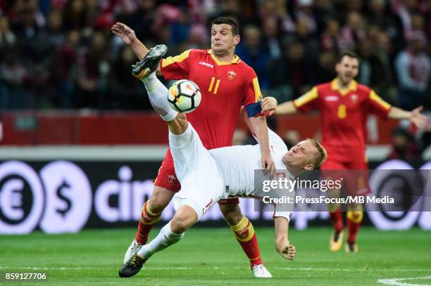 Fatos Beciraj, Kamil Glik during the FIFA 2018 World Cup Qualifier between Poland and Montenegro on October 8, 2017 in Warsaw, Poland.