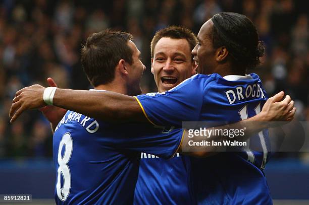 Frank Lampard, John Terry and Didier Drogba of Chelsea celebrate their team's second goal scored by Drogba during the Barclays Premier League match...