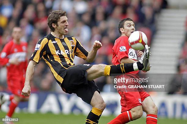 Middlesbrough's English player Stewart Downing challenges Hull City's Welsh player Samuel Ricketts during the English FA Premier League football...