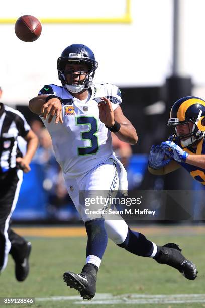 Russell Wilson of the Seattle Seahawks throws a pass during the game against the Los Angeles Rams at the Los Angeles Memorial Coliseum on October 8,...