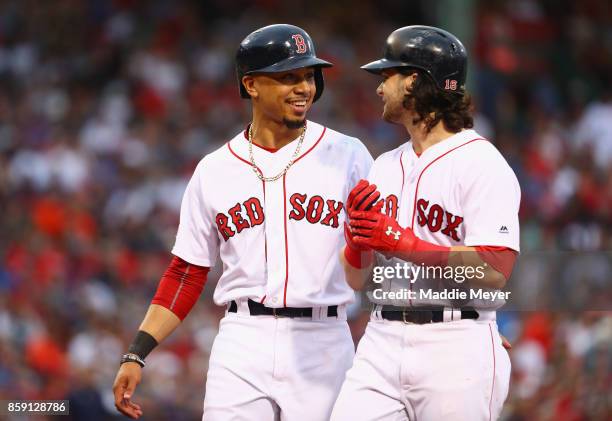 Mookie Betts and Andrew Benintendi of the Boston Red Sox talk during game three of the American League Division Series between the Houston Astros and...