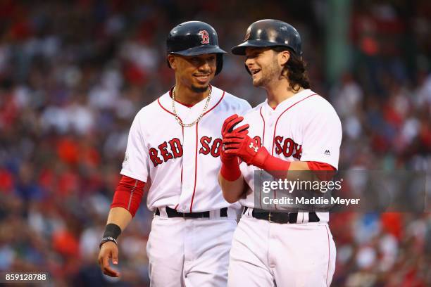 Mookie Betts and Andrew Benintendi of the Boston Red Sox talk during game three of the American League Division Series between the Houston Astros and...