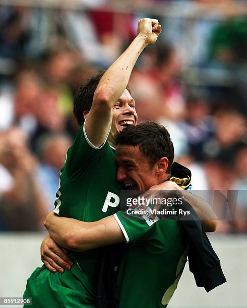Sascha Riether of Wolfsburg is celebrated by his team mate Christian Gentner after scoring his team's second goal during the Bundesliga match between...