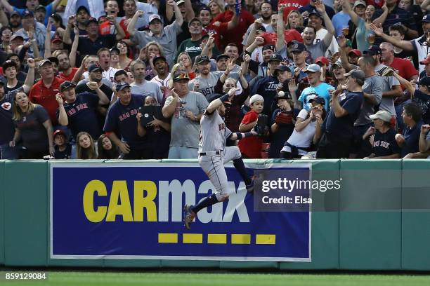 Josh Reddick of the Houston Astros is unable to catch a three-run home run ball hit by Jackie Bradley Jr. #19 of the Boston Red Sox in the seventh...