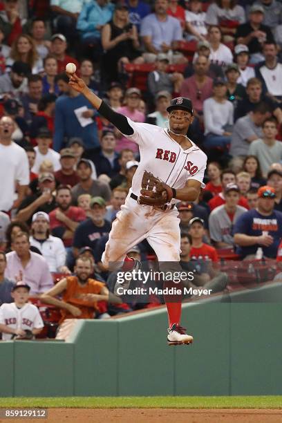 Xander Bogaerts of the Boston Red Sox throws to first base during game three of the American League Division Series between the Houston Astros and...