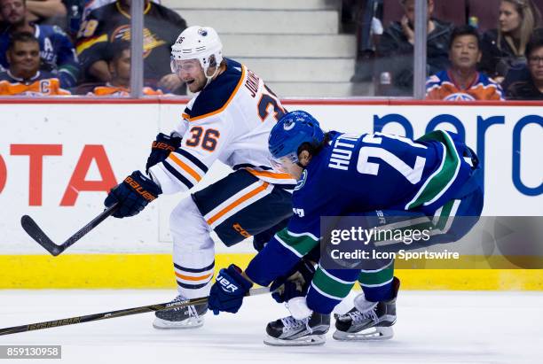 Vancouver Canucks Defenceman Ben Hutton attempts to check Edmonton Oilers Left Wing Jussi Jokinen during the Edmonton Oilers game versus the...