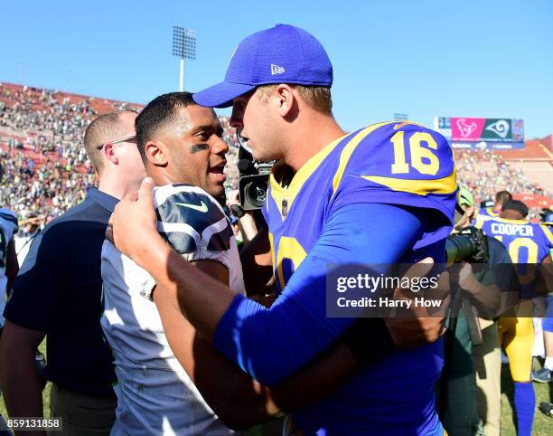 Russell Wilson of the Seattle Seahawks meets Jared Goff of the Los Angeles Rams after a 16-10 Seahawks win at Los Angeles Memorial Coliseum on...