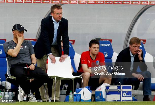 Assistant coach Peter Zeidler, head coach Ralf Rangnick, physiotherapist Peter Geigle and manager Jan Schindelmeiser of Hoffenheim react during the...