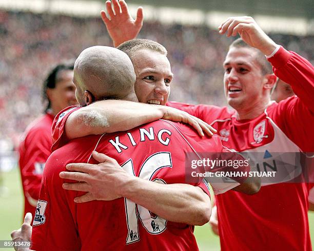 Middlesbrough's Jamaican striker Marlon King is congratulated after scoring their third goal by Tony McMahon and Andrew Taylor during the English FA...