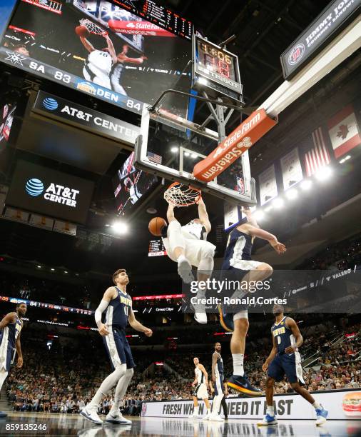 Matt Costello of the San Antonio Spurs dunks against the Denver Nuggets at AT&T Center on October 8, 2017 in San Antonio, Texas. NOTE TO USER: User...
