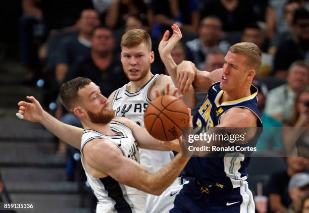 Matt Costello of the San Antonio Spurs battles Mason Plumlee of the Denver Nuggets at AT&T Center on October 8, 2017 in San Antonio, Texas. NOTE TO...