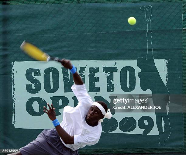 Phillip Muhlwa of Zimbabwe slams a shot aginist Justin Bower during the Soweto Tennis Open Qualifying Tournament in Soweto on April 11, 2009 at the...