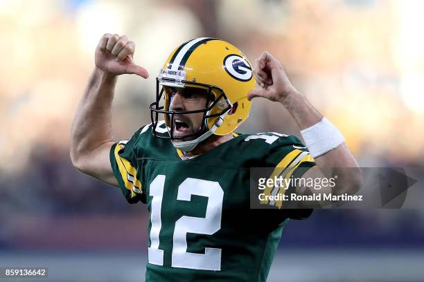 Aaron Rodgers of the Green Bay Packers reacts after throwing the game winning touchdown against the Dallas Cowboys in the fourth quarter at AT&T...
