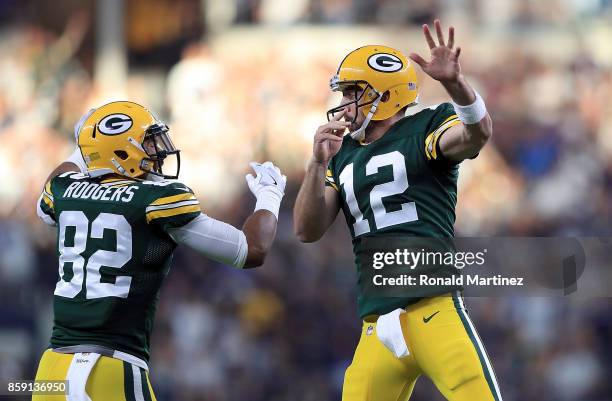 Richard Rodgers and Aaron Rodgers of the Green Bay Packers celebrate the game winning touchdown against the Dallas Cowboys in the fourth quarter at...