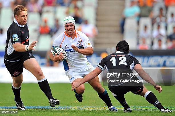 Heinrich Brussow of the Cheetahs slips through the Sharks defence during the Super 14 match between Cheetahs and the Sharks at Vodacom Park on April...