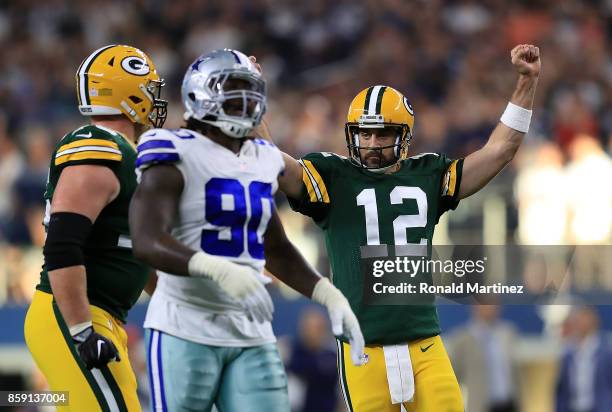 Aaron Rodgers of the Green Bay Packers reacts after throwing the game winning touchdown against the Dallas Cowboys in the fourth quarter at AT&T...