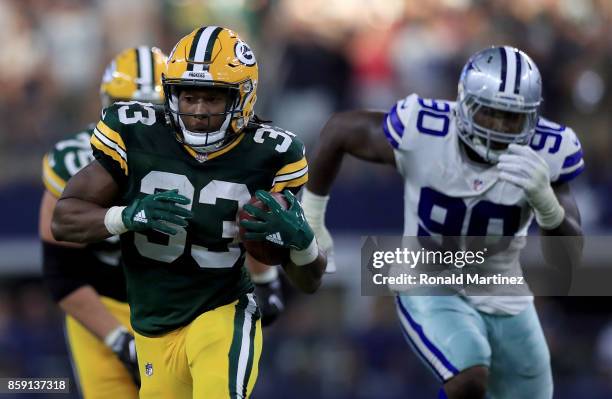 Aaron Jones of the Green Bay Packers runs the ball against the Dallas Cowboys in the fourth quarter at AT&T Stadium on October 8, 2017 in Arlington,...