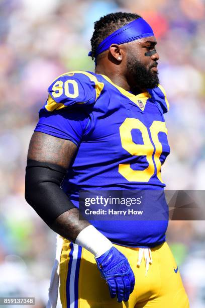 Michael Brockers of the Los Angeles Rams walks on the field before the game against the Seattle Seahawks at the Los Angeles Memorial Coliseum on...