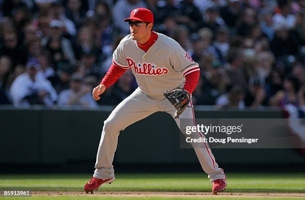 Third baseman Greg Dobbs of the Philadelphia Phillies plays defense against the Colorado Rockies during MLB action on Opening Day at Coors Field on...