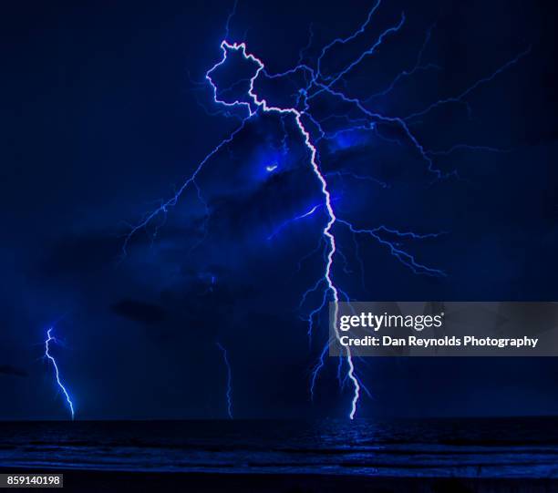 dancing sky as lighting bolt strikes during thunderstorm-close up - thunderstorm ocean blue stock pictures, royalty-free photos & images