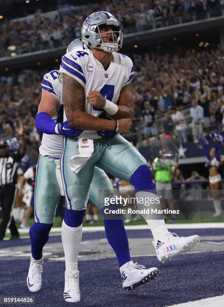 Dak Prescott celebrates his touchdown run with Jason Witten of the Dallas Cowboys in the fourth quarter against the Green Bay Packers at AT&T Stadium...