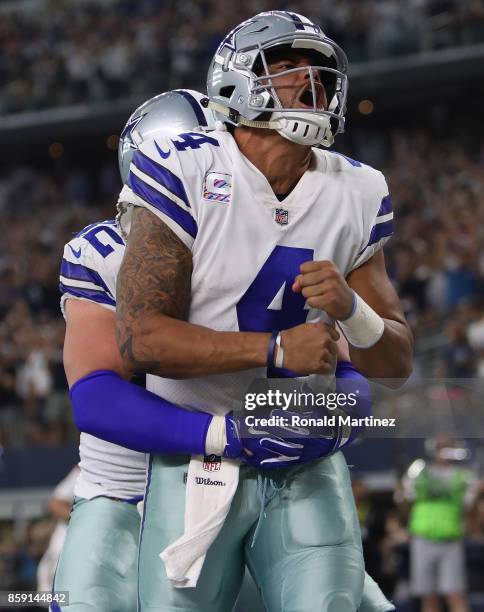 Dak Prescott celebrates his touchdown run with Jason Witten of the Dallas Cowboys in the fourth quarter against the Green Bay Packers at AT&T Stadium...