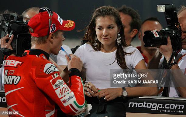 MotoGP rider Casey Stoner of Australia celebrates with his wife Adriana after winning the first place for pole position during official qualifying at...