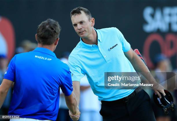 Brendan Steele shakes hands with Graham DeLaet of Canada after finishing his round on the 18th hole during the final round of the Safeway Open at the...