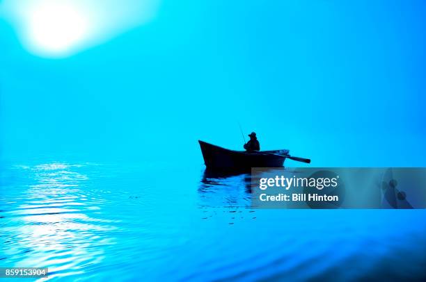 blue lake rowboat - bill hinton stock pictures, royalty-free photos & images