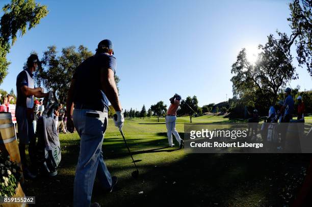 Bill Haas plays his shot from the 16th tee as Phil Mickelson looks on during the final round of the Safeway Open at the North Course of the Silverado...