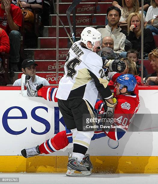 Matt Cooke of the Pittsburgh Penguins checks Maxim Lapierre of the Montreal Canadiens during their NHL game at the Bell Centre April 11, 2009 in...