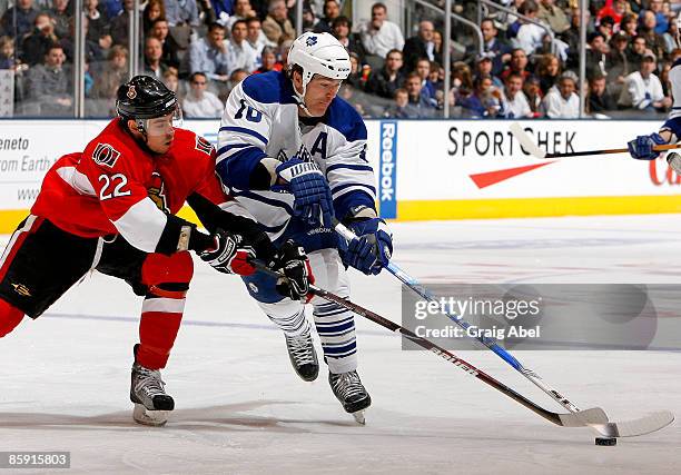 Brad May of the Toronto Maple Leafs battles for the puck with Chris Kelly of the Ottawa Senators during game action April 11, 2009 at the Air Canada...