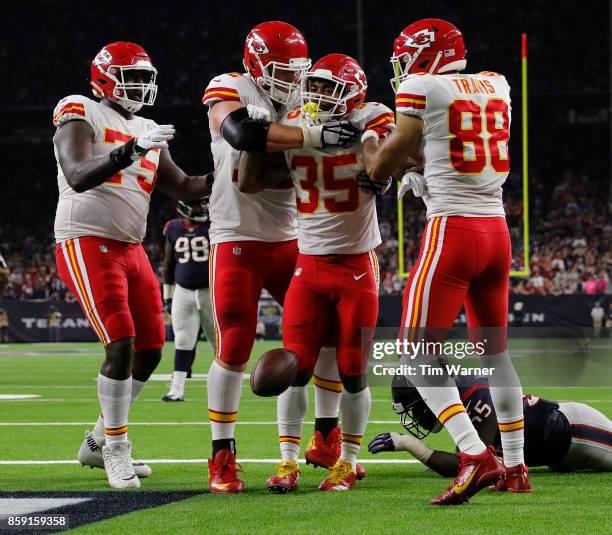 Charcandrick West of the Kansas City Chiefs celebrates at touchdown reception with teammates against the Houston Texans in the second quarter at NRG...